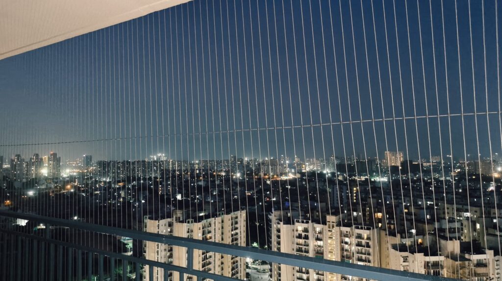 SS 316 grade invisible grill installation in a Delhi high-rise apartment balcony